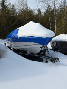 A shrink wrapped boat at Hidden Acres RV & Boat Storage