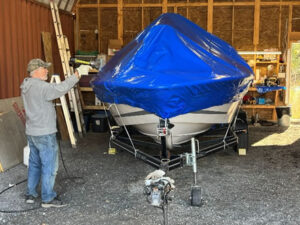 A boat undergoing shrink wrapping onsite at Hidden Acres RV & Boat Storage in the Ottawa Valley