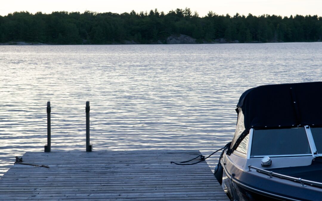 A boat tied up at a dock on a summer's day.