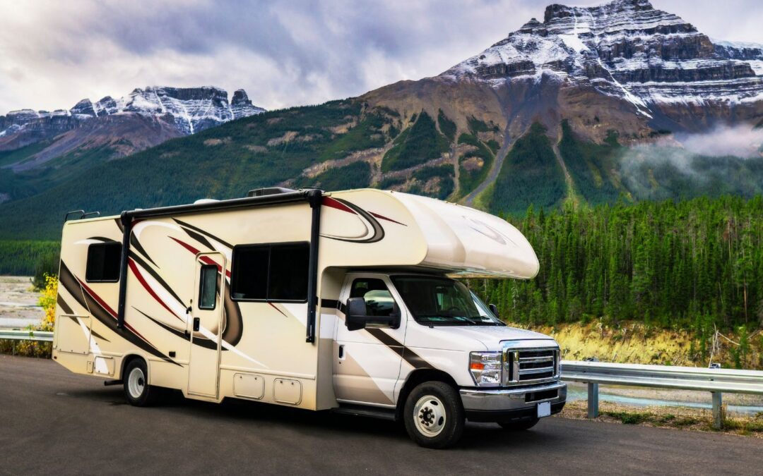An RV on the road in a scenic location.