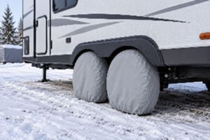 An RV in winter with wheel covers in place